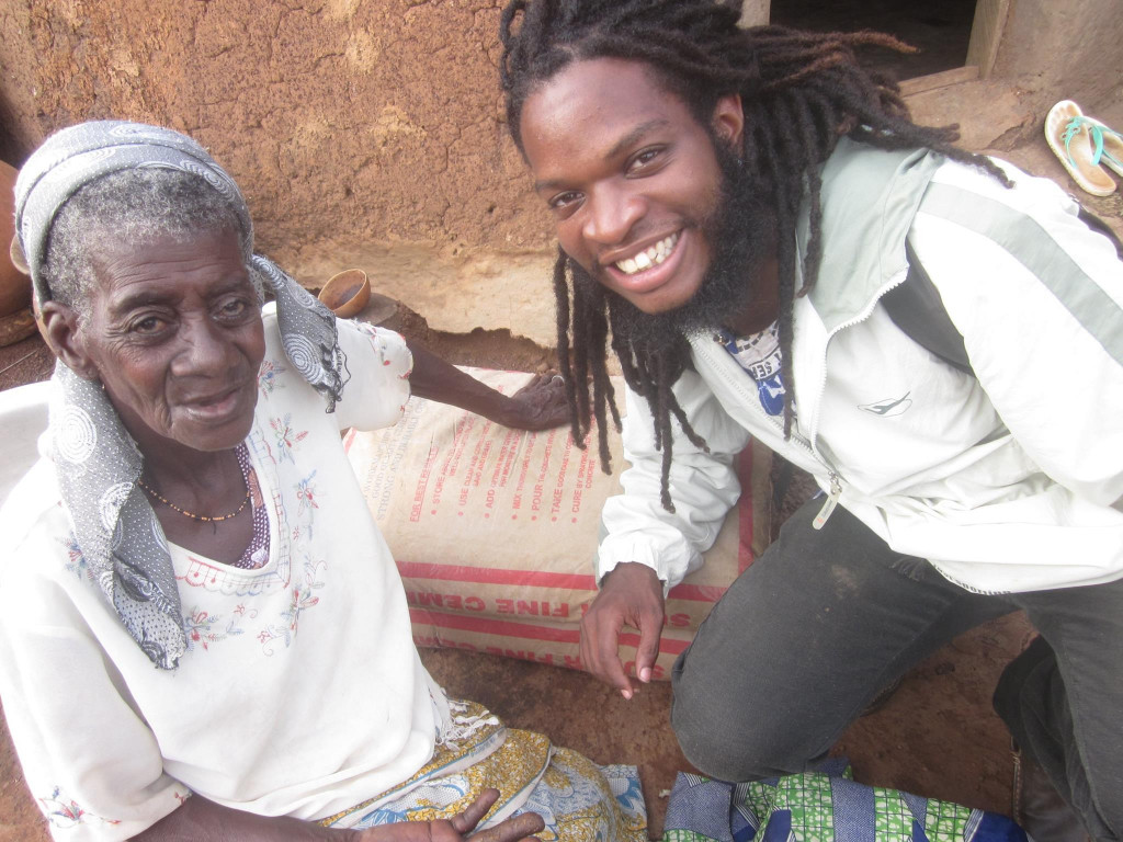 2015-2016 HSC volunteer Christian Hayden visits with Fatima, a banished woman living in the Kukuo camp for alleged witches.